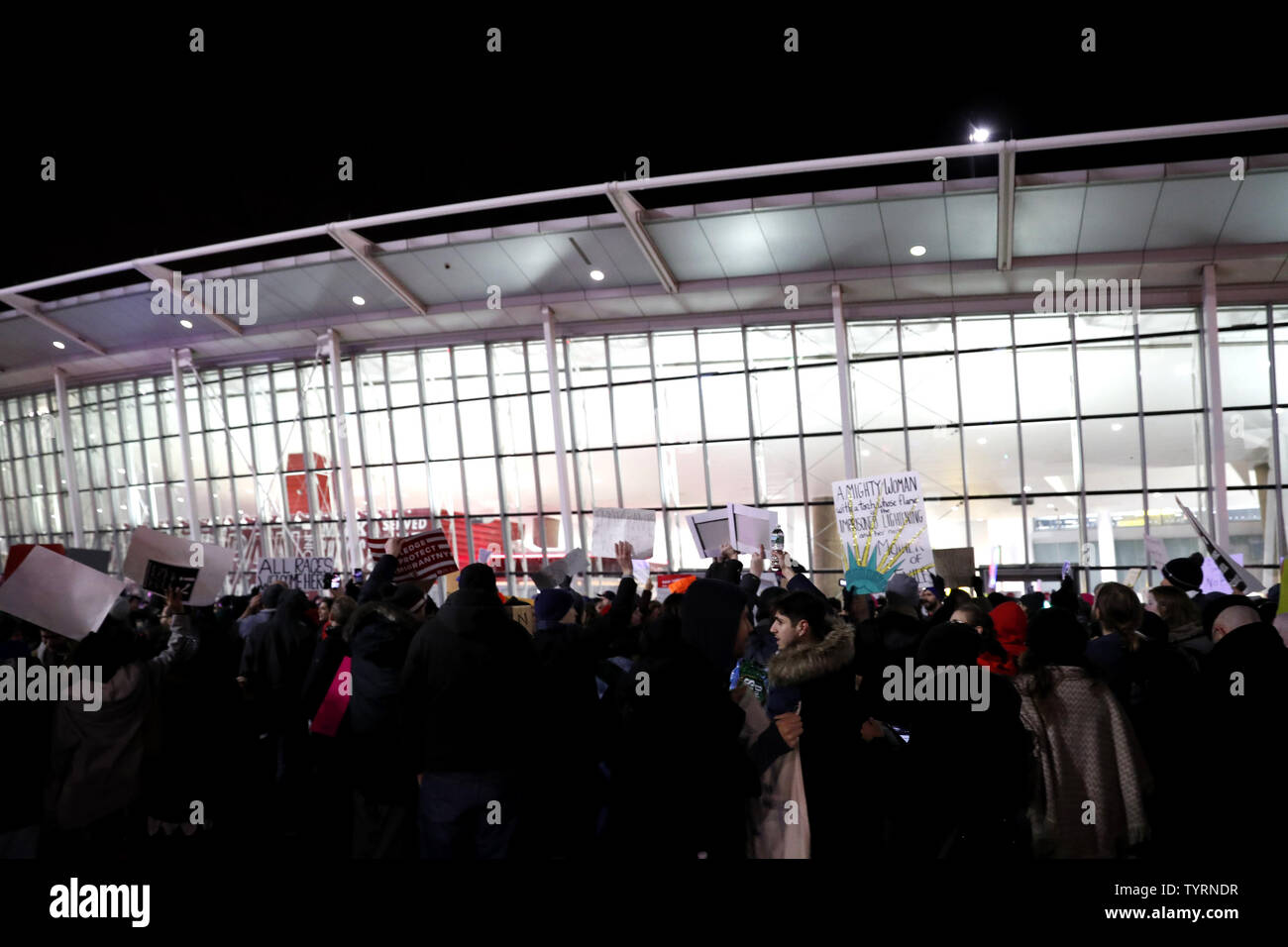 Protesters hold up signs protesting President Donald Trumps immigration policies at JFK Airport in New York City on January 28, 2017. President Trump signed a controversial executive order that halted refugees and residents from predominantly Muslim countries from entering the United States. People gathered at airports across the United States on Saturday to protest President Donald Trump's immigration policies.     Photo by John Angelillo/UPI Stock Photo
