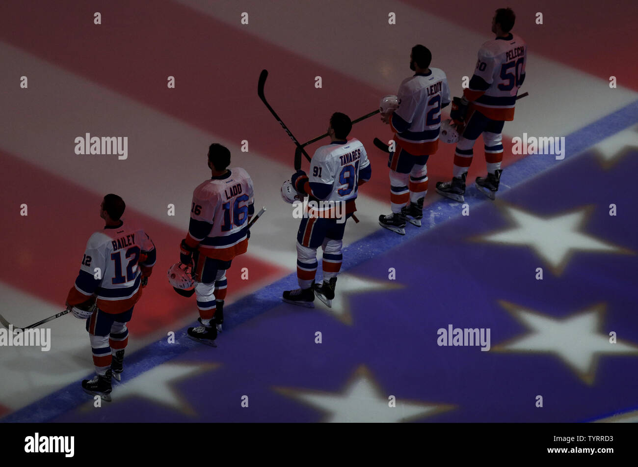 New York Islanders Josh Bailey, Cat Clutterbuck, John Tavares, Nick Leddy  and Adam Pelech stand in the ice for the National Anthem before the game  against the New York Rangers at Madison