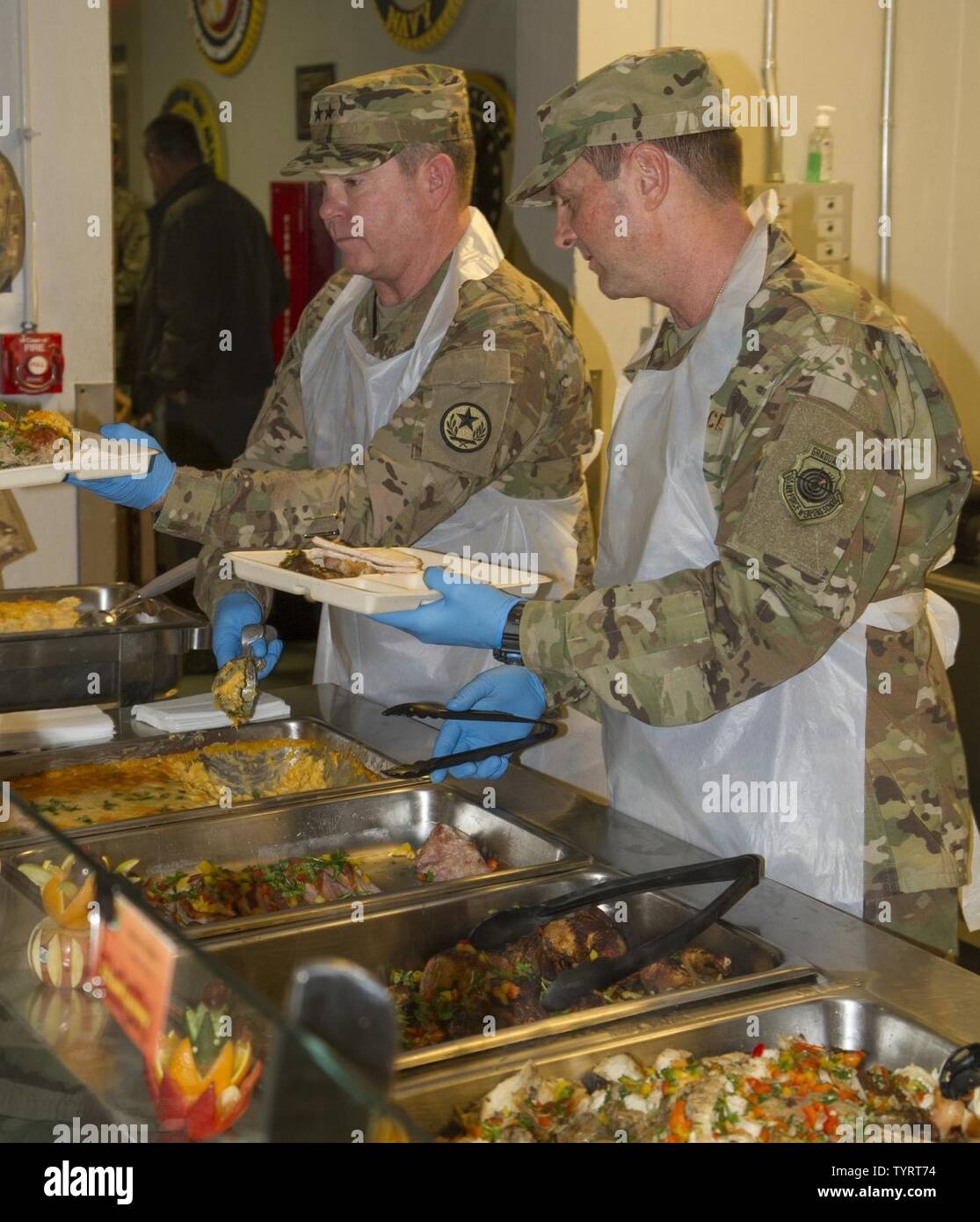Gen. Joseph Lengyel, Chief National Guard Bureau, and Airforce, Maj. Gen. John Nichols, The Adjutant General, Texas, serve Thanksgiving lunch to coalition forces and Department of the Army civilians at Bagram Airfield, Afghanistan. Stock Photo