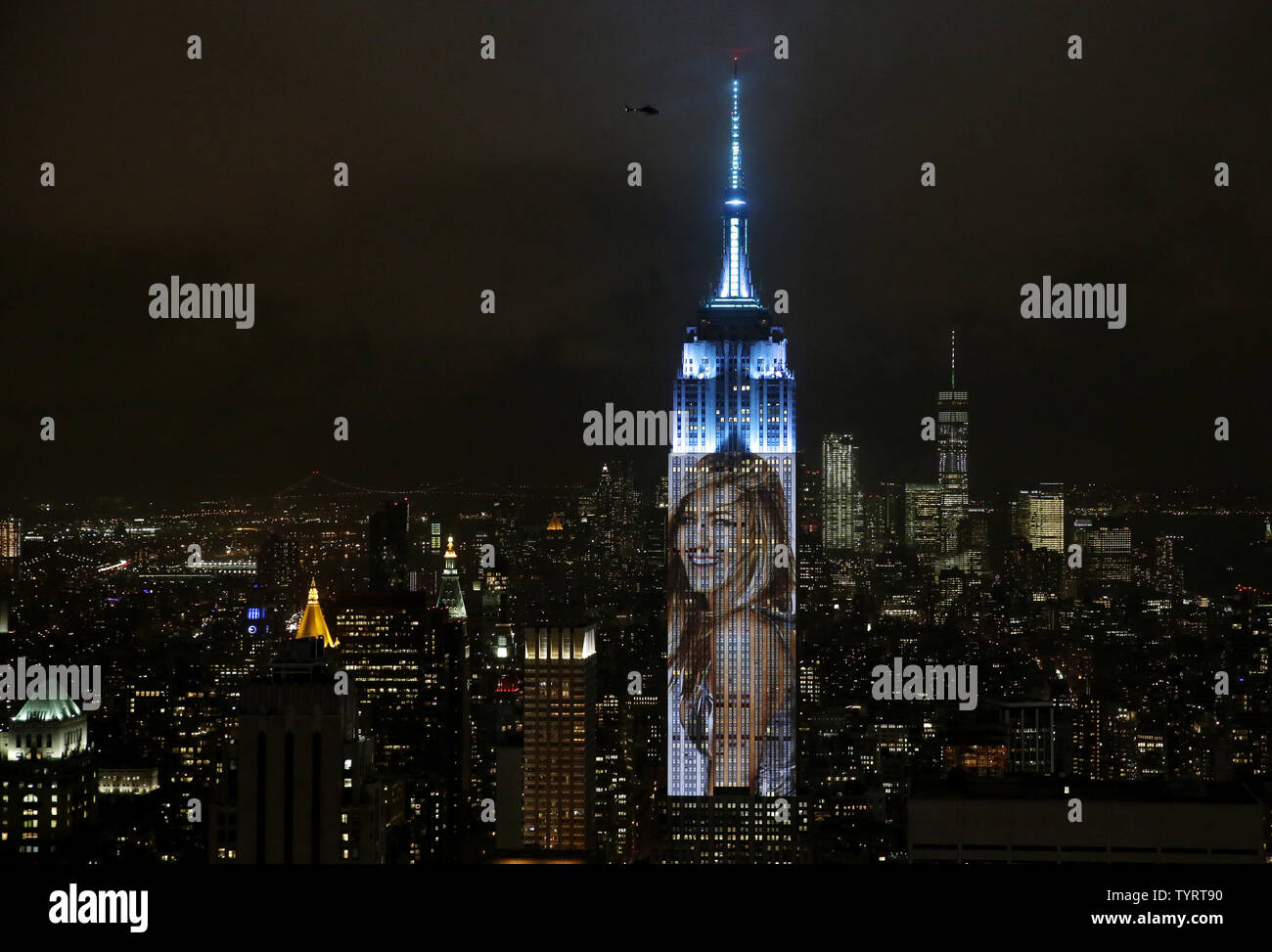 An artist rendering image of Jennifer Aniston is projected onto the Empire State Building in the Manhattan skyline to celebrate Harper Bazaar's 150th anniversary on April 19, 2017 in New York City. Spanning 42 floors of the building and rising 500 feet high, the show featured iconic fashion images of everyone from Audrey Hepburn to Kate Moss, including iconic works by the likes of Andy Warhol.     Photo by John Angelillo/UPI Stock Photo