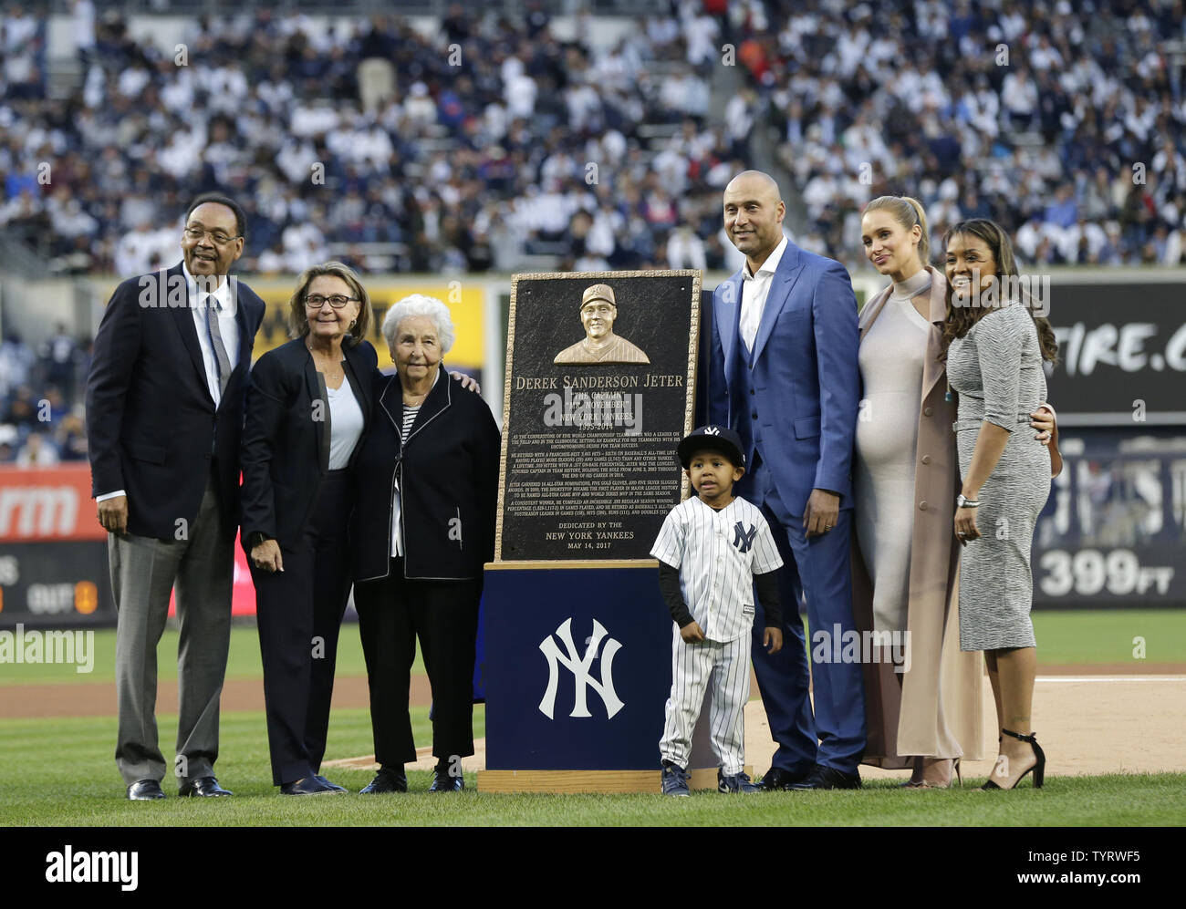 Derek Jeter stands on the field with Hannah Jeter and other members of his family at a ceremony retiring his number before the Houston Astros play the New York Yankees at Yankee Stadium in New York City on May 14, 2017. The New York Yankees former shortstop had his No. 2 retired and was also honored with a plaque in Monument Park.     Photo by John Angelillo/UPI Stock Photo