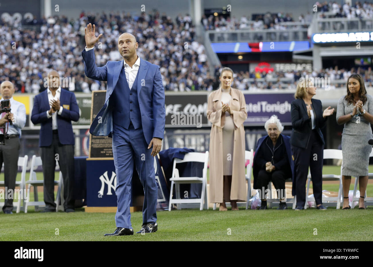 Derek Jeter waves to fans on the field with Hannah Jeter for a ceremony retiring his number before the Houston Astros play the New York Yankees at Yankee Stadium in New York City on May 14, 2017. The New York Yankees former shortstop had his No. 2 retired and was also honored with a plaque in Monument Park.     Photo by John Angelillo/UPI Stock Photo