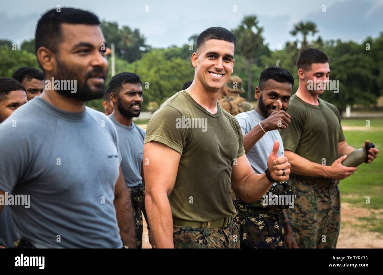 TRINCOMALEE, Sri Lanka (Nov. 24, 2016) Sgt. Anthony Sandusky, a squad leader with Alpha Co., Battalion Landing Team 1st Bn., 4th Marines, 11th Marines Expeditionary Unit, and a Sri Lankan Marine give a thumbs-up during physical training as part of a Theater Security Cooperation engagement at Sri Lanka Naval Base, Trincomalee, Nov. 24, 2016. The U.S. and Sri Lankan Marines bonded and learned about each other’s cultures through several days of training together. This is the Sri Lankan Marines’ first engagement with another Marine Corps as their Corps was stood up within the past four months.  Wo Stock Photo