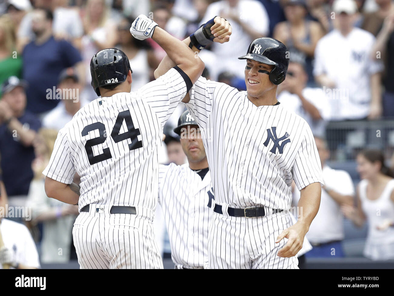 New York Yankees Gary Sanchez celebrates at home plate with Aaron Judge after hitting a 3-run home run in the 5th inning against the Texas Rangers at Yankee Stadium in New York City on June 25, 2017.    Photo by John Angelillo/UPI Stock Photo