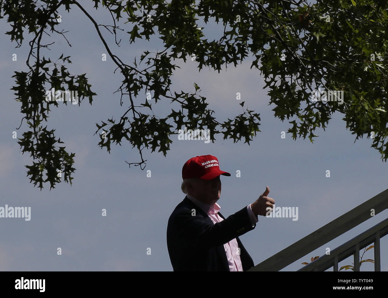 United States President Donald Trump gives a thumbs up when he arrives at Trump National Golf Club for the final round of the LPGA U.S. Women's Open Championship  in Bedminster, NJ on July 14, 2017.     Photo by John Angelillo/UPI Stock Photo