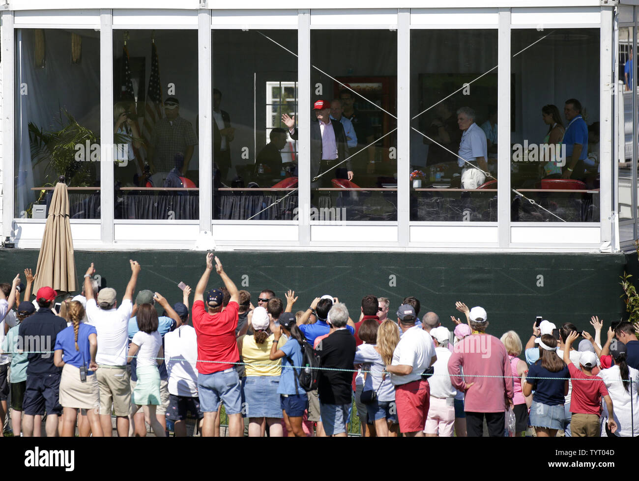 United States President Donald Trump waves at fans from his viewing booth at Trump National Golf Club for the final round of the LPGA U.S. Women's Open Championship  in Bedminster, NJ on July 14, 2017.     Photo by John Angelillo/UPI Stock Photo