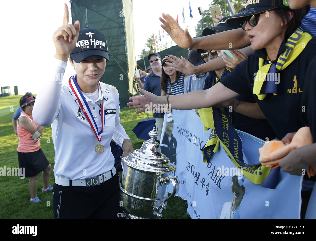 Rookie Sung Hyun Park of South Korea celebrates with fans as she holds the championship trophy at Trump National Golf Club after the final round of the LPGA U.S. Women's Open Championship  in Bedminster, NJ on July 14, 2017. Park wins her first major with a score of 11 under par.      Photo by John Angelillo/UPI Stock Photo