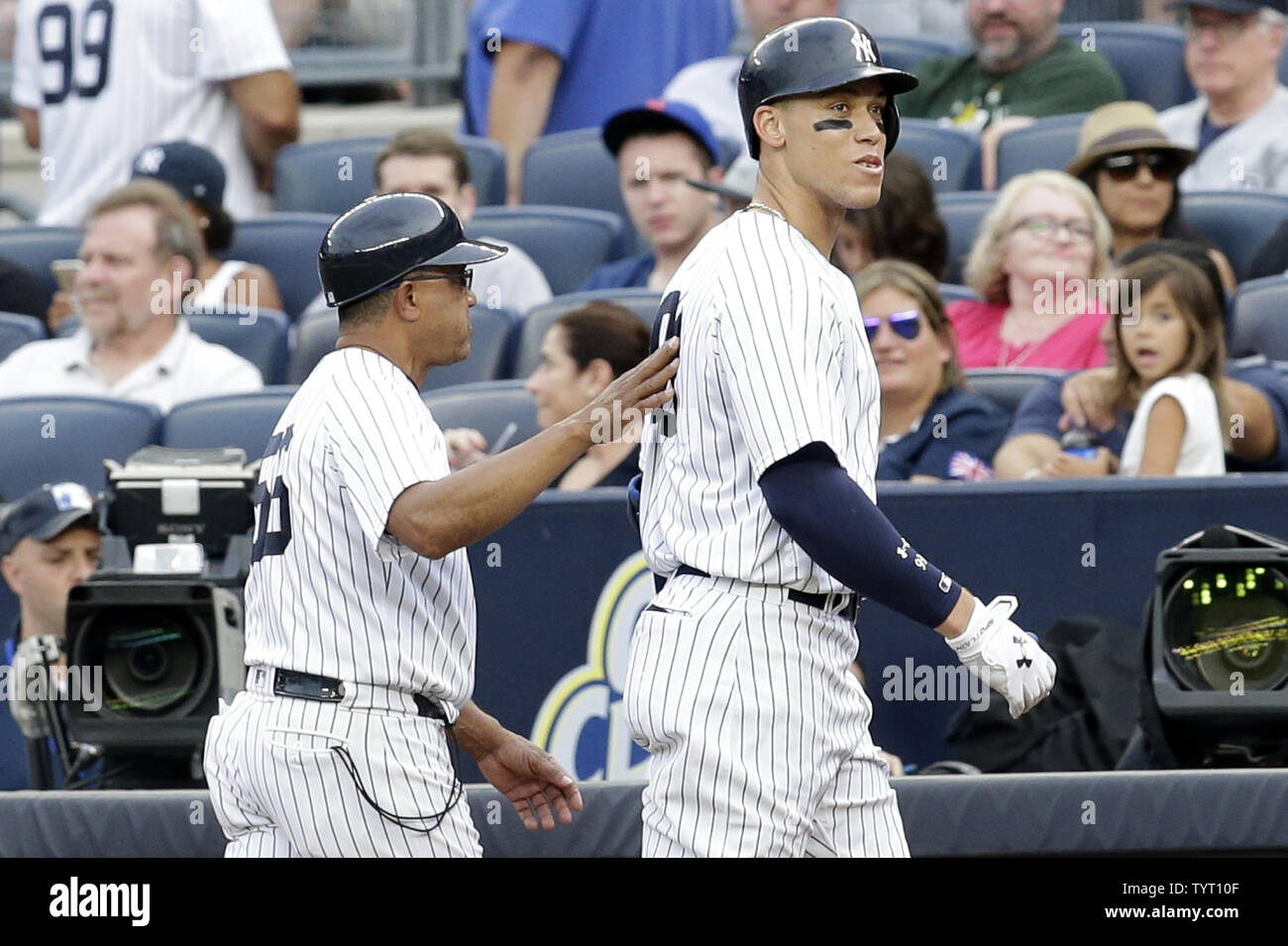 New York Yankees first base coach Tony Pena puts his arm on the back of
