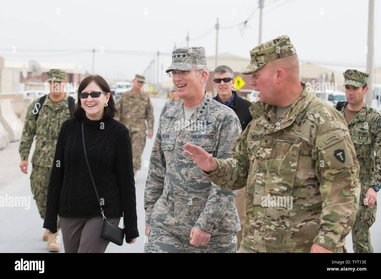 U.S. Army Brig. Gen. Lee Henry, right, Train, Advise and Assist Command – South commander, escorts U.S. Air Force Gen. Paul J. Selva, center, vice chairman of the Joint Chiefs of Staff, and his wife, Ricki Selva, to meet with U.S. service members at Kandahar Airfield, Afghanistan, Nov. 24, 2016. Gen. Selva and Mrs. Selva visited troops across Afghanistan to spend Thanksgiving Day with them and thank them for their service. Stock Photo