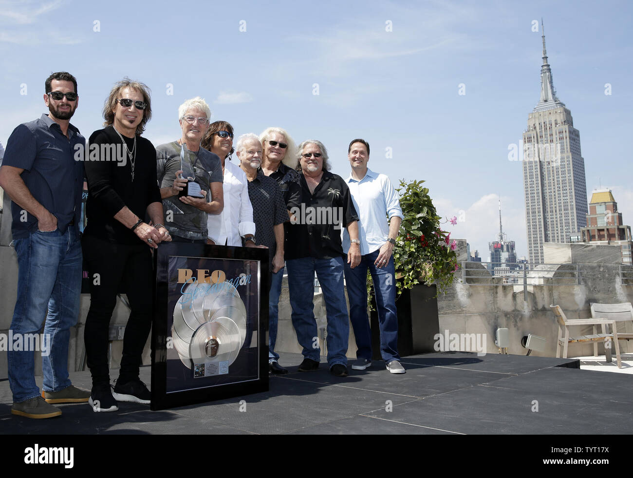 MTV original VJ Mark Goodman and Kevin Cronin of REO Speedwagon along with Sony executives and band members stand on Sony Music Rooftop when the 1980 album 'Hi Infidelity'  is awarded a Recording Industry Association of America RIAA 10X Diamond Award for surpassing 10 million units in the United States on August 17, 2017 in New York City. Hi Infidelity is the ninth studio album by the band REO Speedwagon, it was released on November 21, 1980. The album became a big hit in the United States peaking at number one on the Billboard 200 REO Speedwagon accepts the award from RIAA, Legacy Recordings Stock Photo