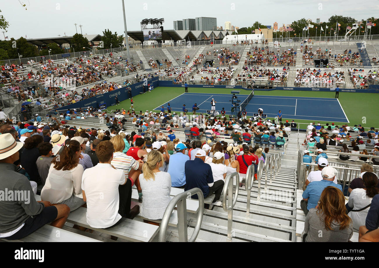 Fans watch a match at the temporary Louis Armstrong Stadium as the new one  is built next door on opening day of the US Open tennis championship at the  USTA Billie Jean