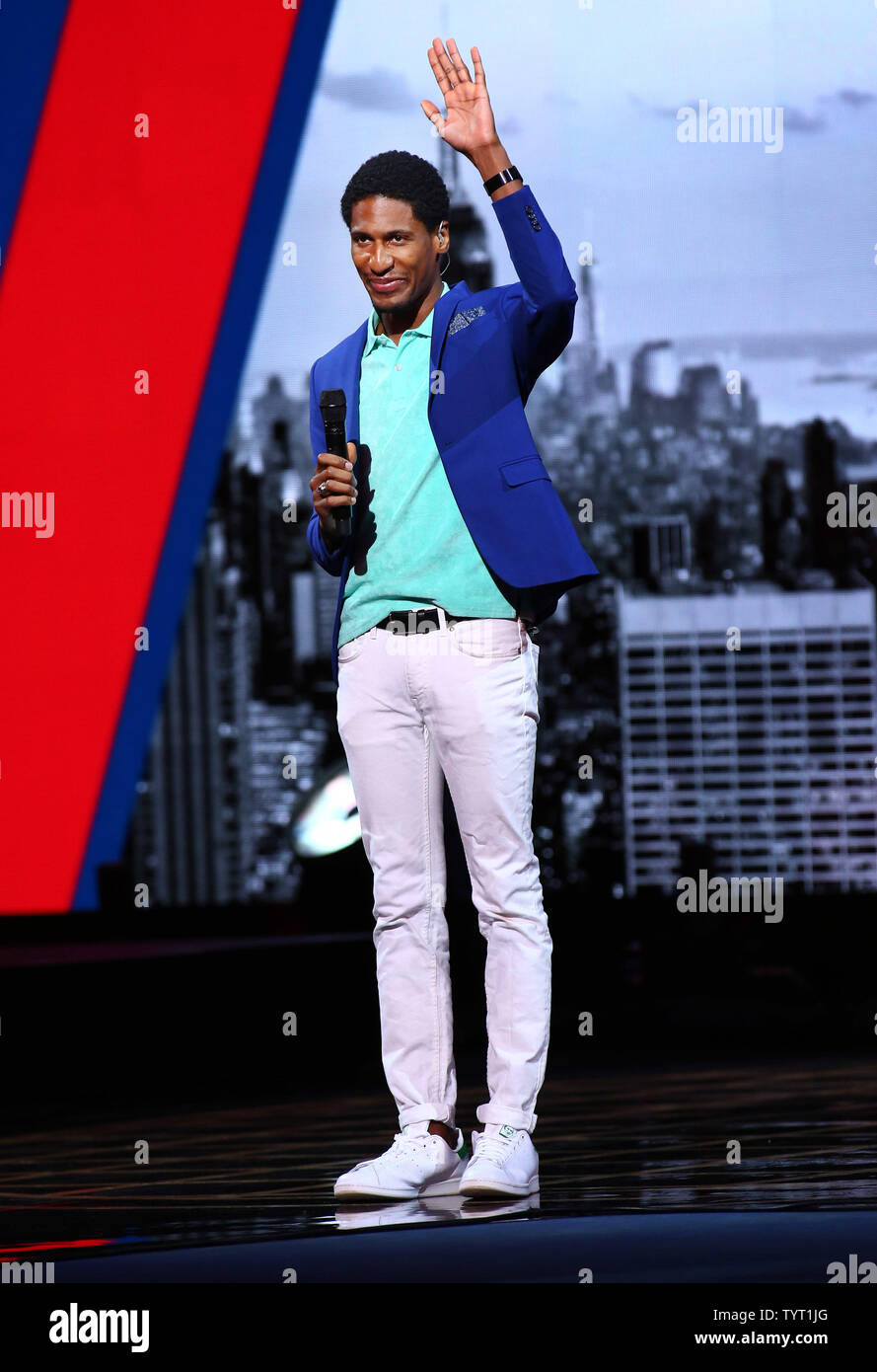 Jon Batiste sings the national anthem during the opening ceremony at