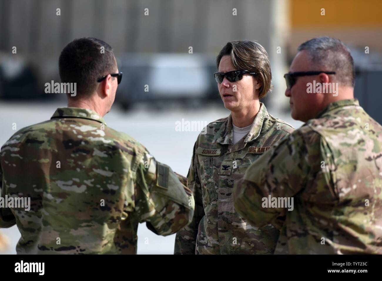 Air Force Gen. Joseph Lengyel, chief, National Guard Bureau, left, talks with Air Force Col. Rebecca Sonkiss, 455th Air Expeditionary Wing, during a Thanksgiving Day troop visit, Bagram Airfield, Bagram, Afghanistan, Nov. 24, 2016. Air Force Chief Master Sgt. Mitchell Brush, senior enlisted advisor to the chief of the National Guard Bureau, is on the right. Stock Photo