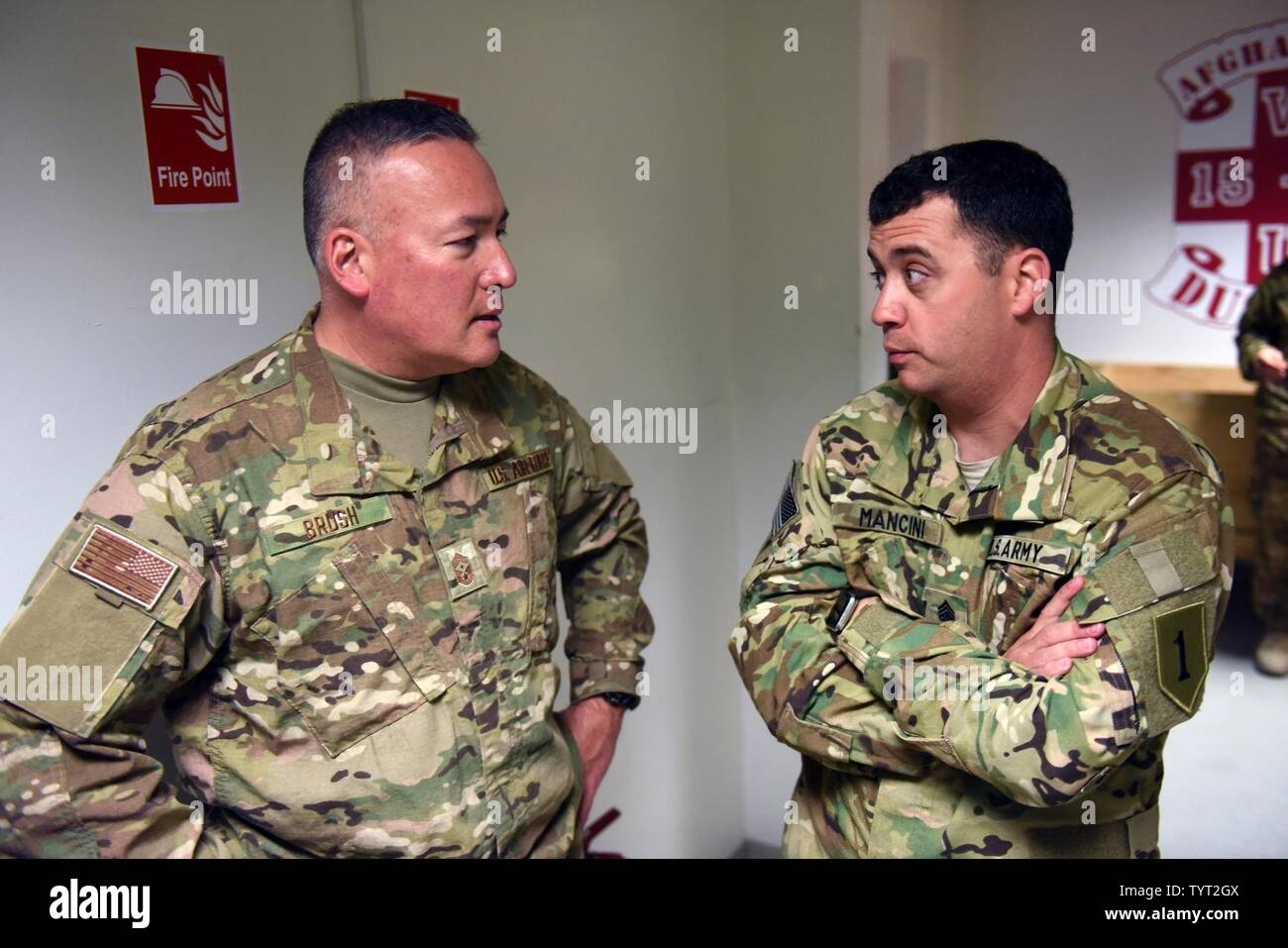 Air Force Chief Master Sgt. Mitchell Brush, senior enlisted advisor to the chief of the National Guard Bureau, talks with a Soldier during a Thanksgiving Day troop visit, Kandahar, Afghanistan, Nov. 24, 2016. Stock Photo