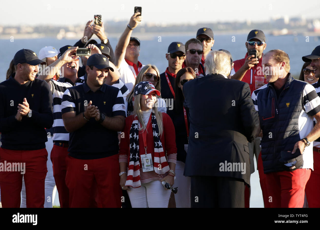 United States President Donald Trump greets players and their wives before he delivers a speech and handing the championship trophy to the United States team after after defeating the International team 19 to 11 in total points at the Presidents Cup on October 1, 2017 at Liberty National Golf Club in Jersey City, New Jersey.    Photo by John Angelillo/UPI Stock Photo