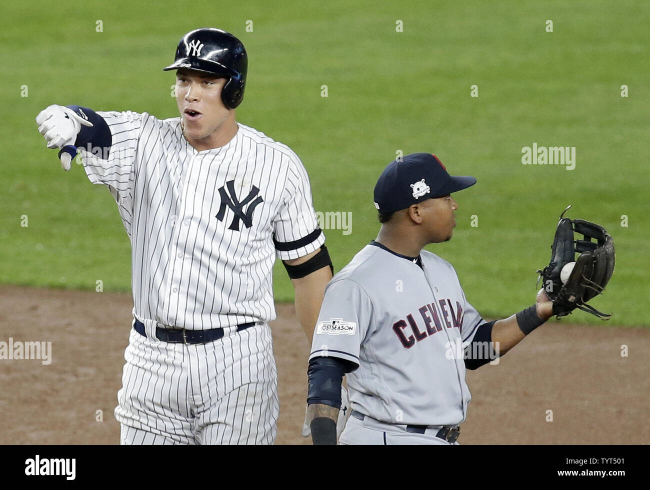 Cleveland Indians Jose Ramirez stands next to New York Yankees Aaron Judge  who puts his thumb down when he reacts after driving in 2 runs with a  double in the 3rd inning