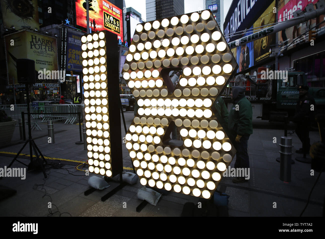 Workers surround the one and eight of the 2018 New Year's Eve Numerals