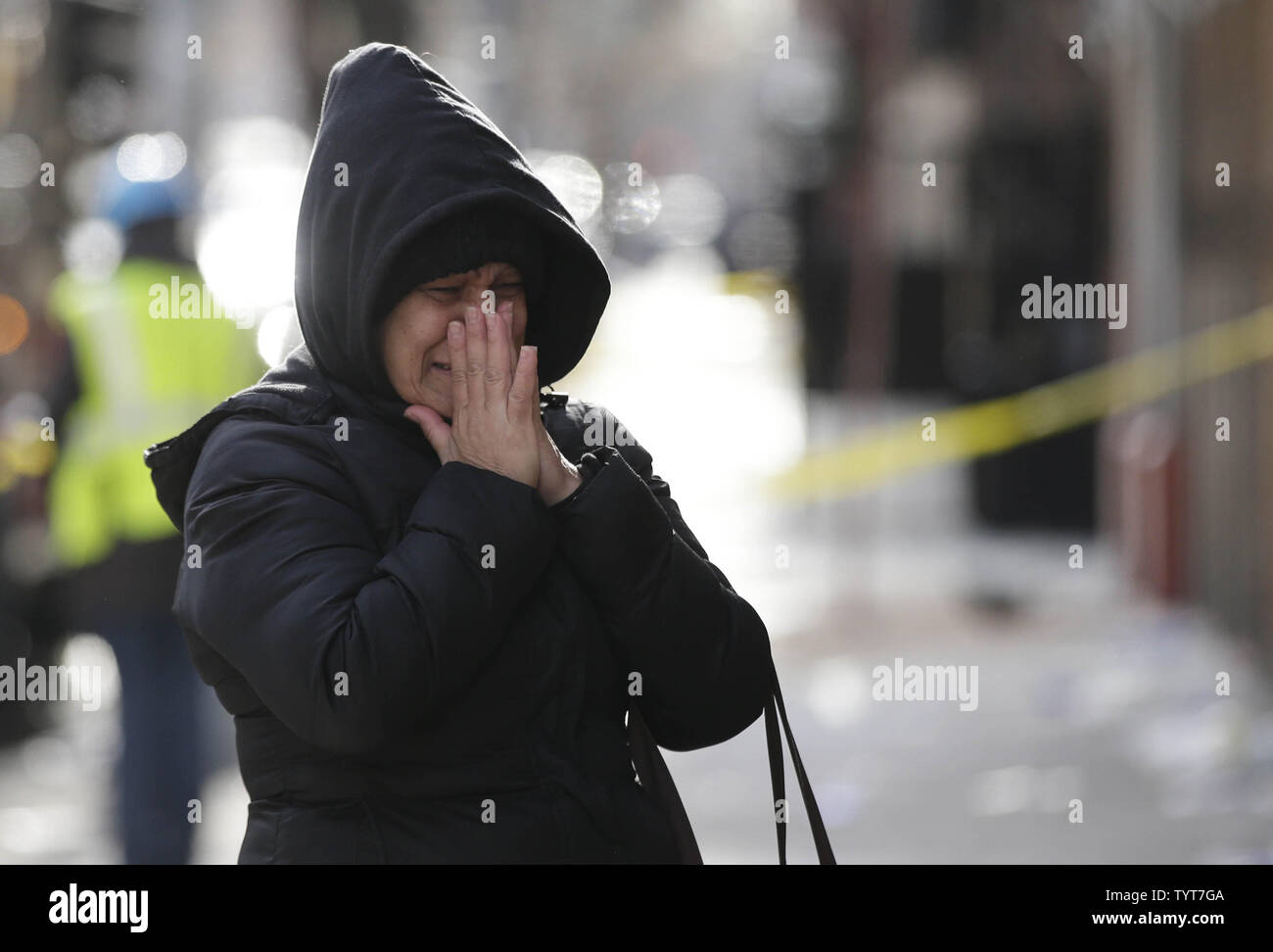 A woman breaks down in tears, cries and reacts at the scene of a fire ...