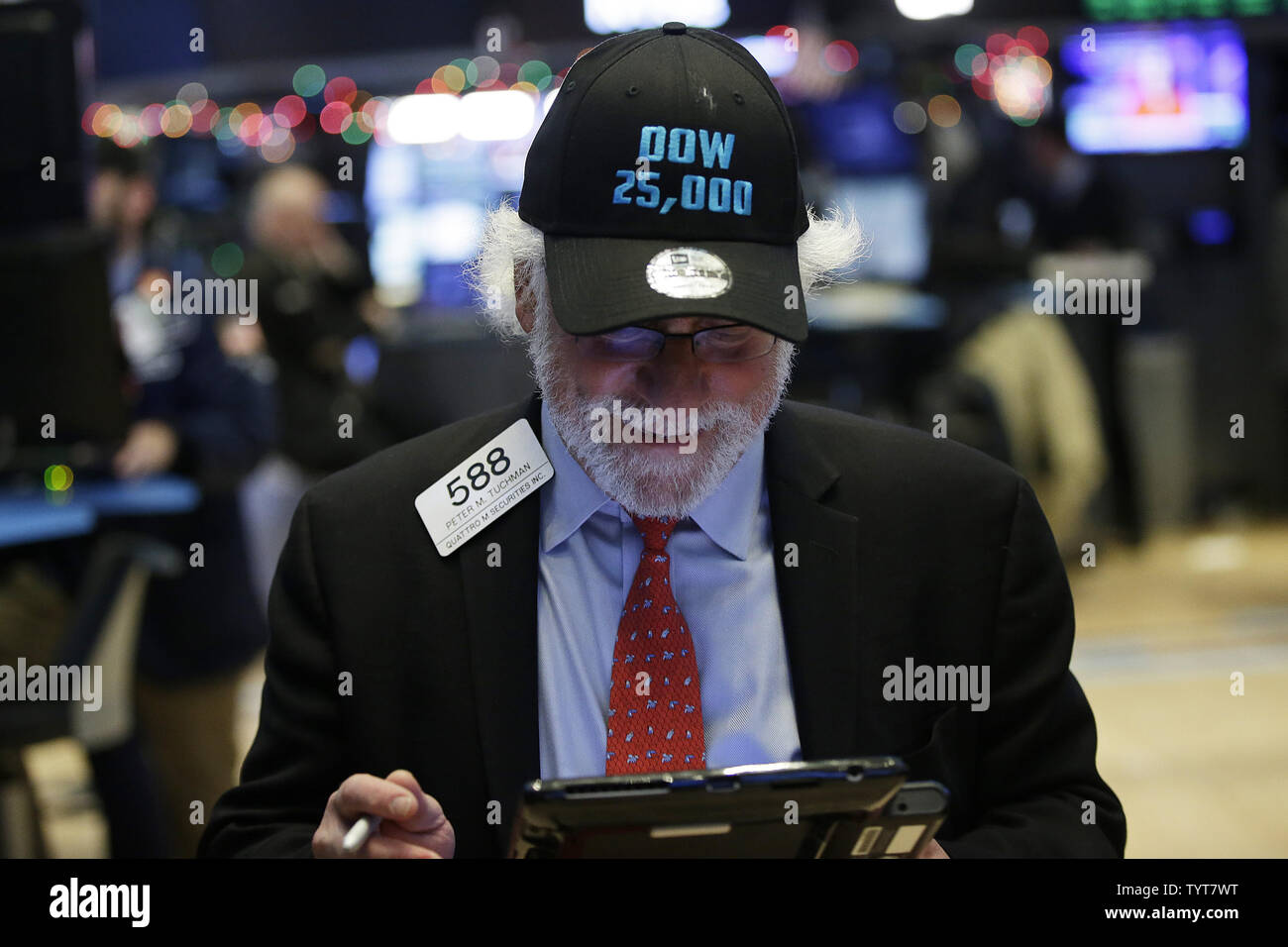 A trader wears a DOW 25,000 hat on the floor of the NYSE at the closing  bell on the day when the Dow Jones Industrial Average closes above the  25,000 mark for