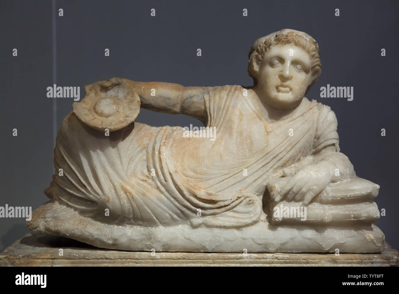 Reclining Man with Omphalos Bowl. Etruscan alabaster cinerary urn with a lid from the grave of the Calisna Sepu family dated from around 150 BC found in Malacena (Monteriggioni), now on display in the Altes Museum in Berlin, Germany. Stock Photo