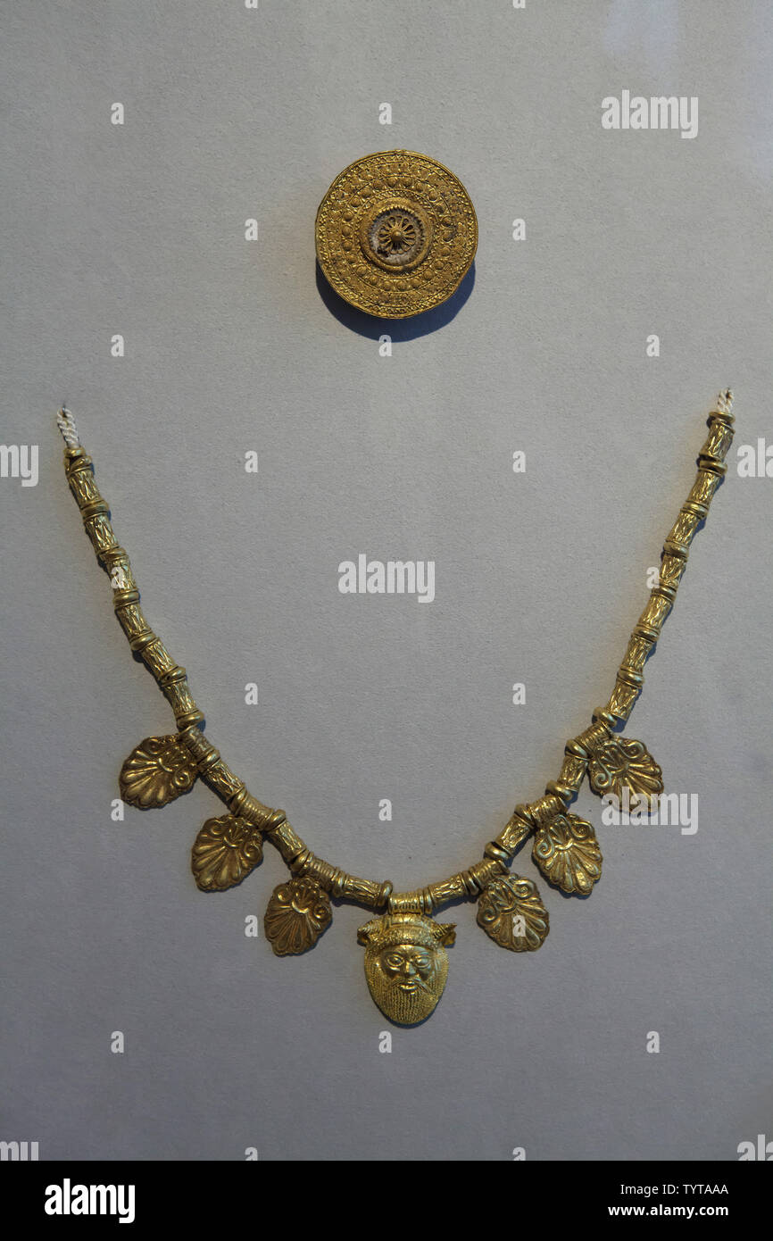 Etruscan decorated golden necklace and fibulae in granulation technique dated from the 6th to 5th century BC on display in the Altes Museum in Berlin, Germany. Stock Photo