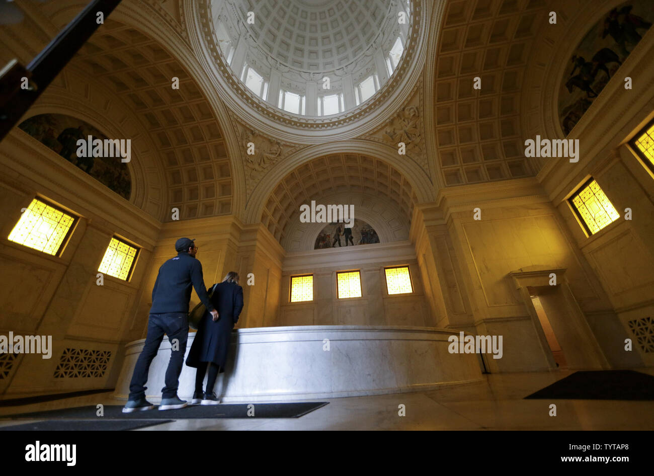Visitors look into the well that holds the vaults which contains the
