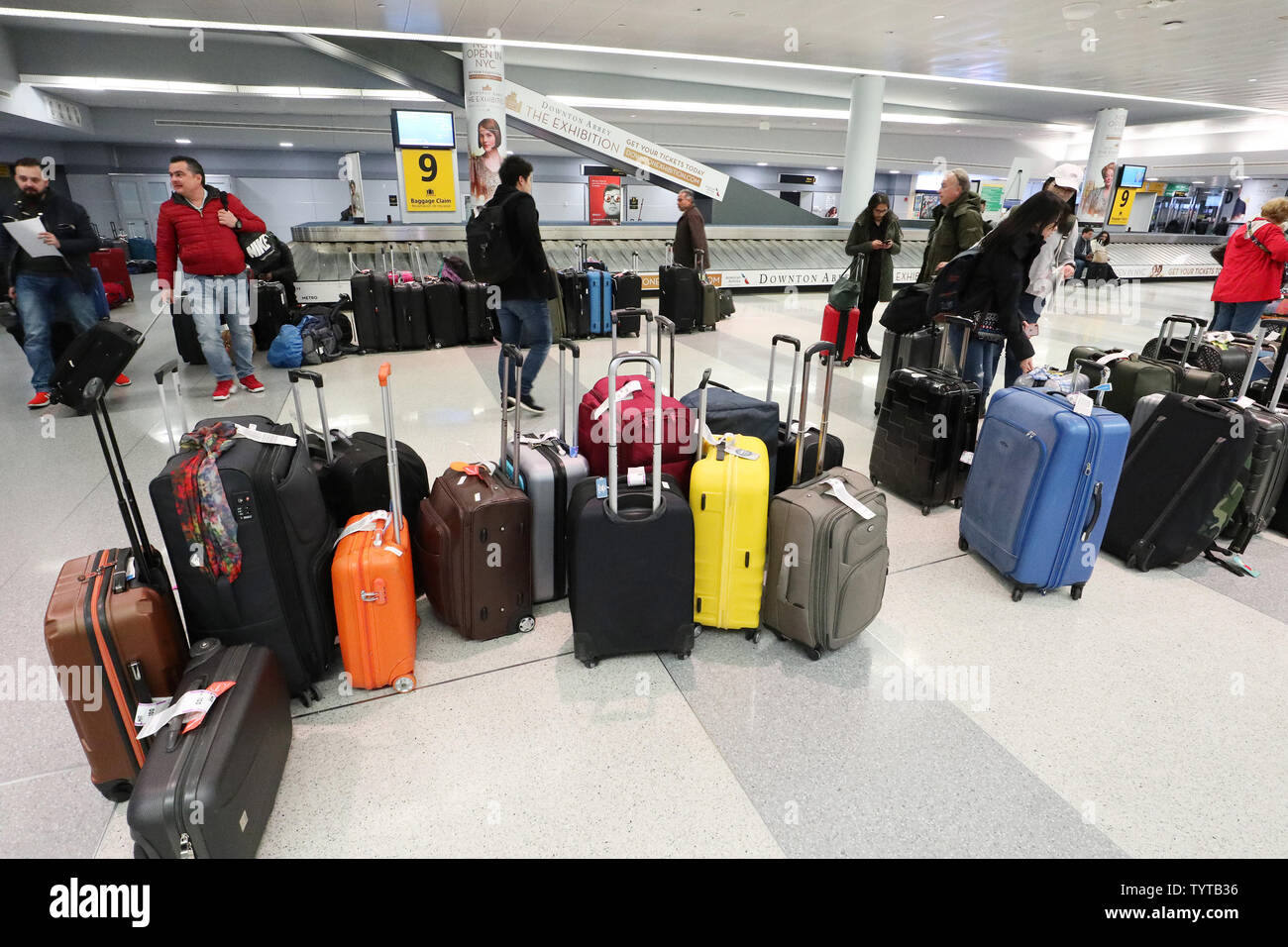 Travelers walk among sections of unclaimed luggage at baggage claim on a day where flights have been canceled do to bad weather at JFK Airport in New York City on March 2, 2018. A Nor'easter slamming the Tri-State Friday grounded flights at John F. Kennedy Airport and forced airlines to cancel hundreds of flights at other area airports. More than 1,500 flights at the three major airports were grounded.     Photo by John Angelillo/UPI Stock Photo