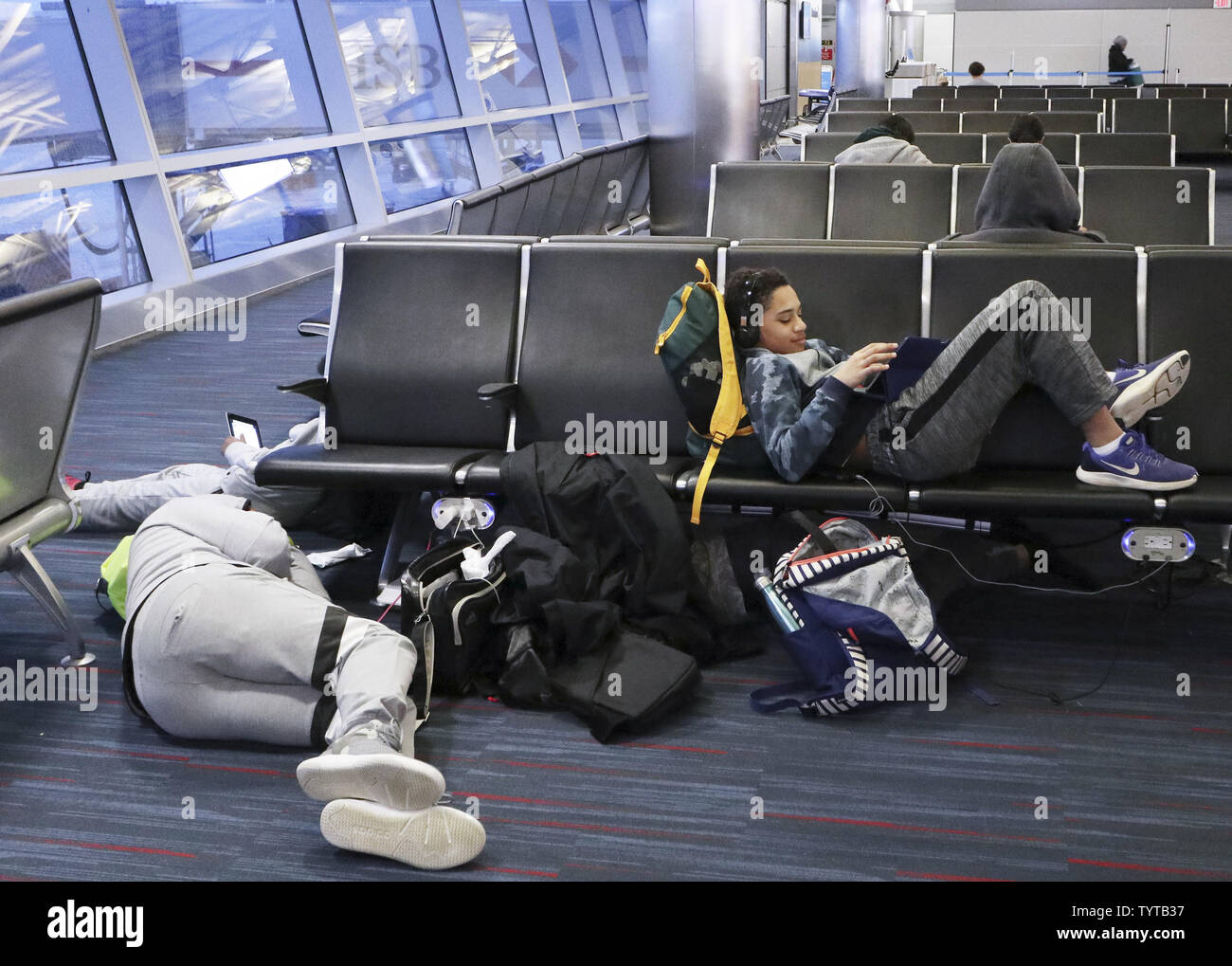 Travelers lie on the floor and chairs at the gates on a day where flights have were canceled do to bad weather at JFK Airport in New York City on March 2, 2018. A Nor'easter slamming the Tri-State Friday grounded flights at John F. Kennedy Airport and forced airlines to cancel hundreds of flights at other area airports. More than 1,500 flights at the three major airports were grounded.     Photo by John Angelillo/UPI Stock Photo