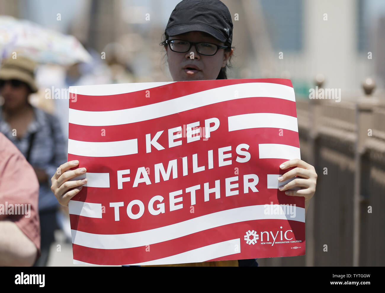 Protesters hold up signs as they walk across the Brooklyn Bridge at the End Family Separation NYC Rally and March in New York City on June 30, 2018. Demonstrators gathered in cities across the United States on Saturday to protest the White House's 'zero tolerance' immigration policy that has prompted the separations and detentions of migrant families.      Photo by John Angelillo/UPI Stock Photo