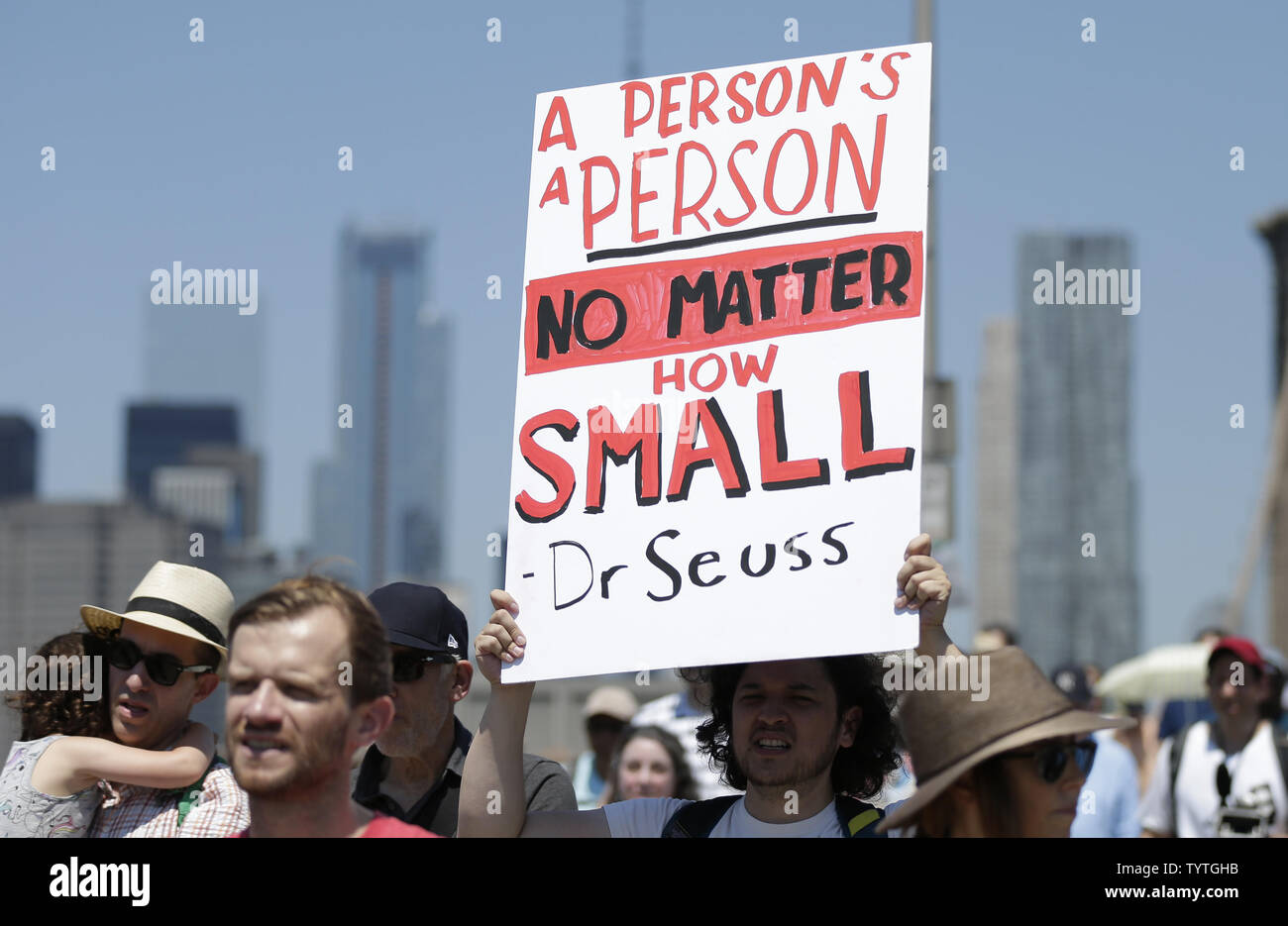 Protesters hold up signs as they walk across the Brooklyn Bridge at the End Family Separation NYC Rally and March in New York City on June 30, 2018. Demonstrators gathered in cities across the United States on Saturday to protest the White House's 'zero tolerance' immigration policy that has prompted the separations and detentions of migrant families.      Photo by John Angelillo/UPI Stock Photo