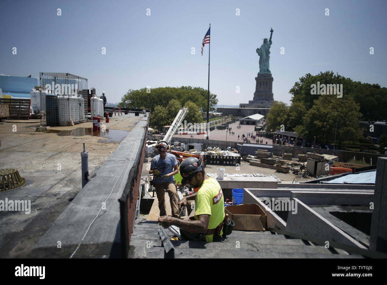 Men wearing hard hats work around the construction site when The Statue of  Liberty-Ellis Island Foundation hosts a press preview of the new Statue of  Liberty Museum to tie-in to the Fourth