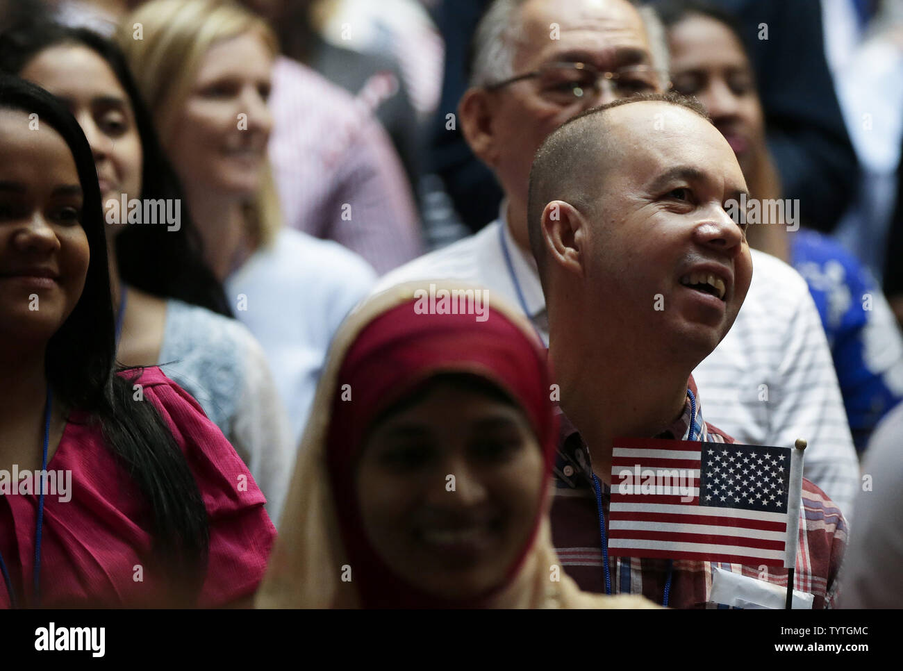 New citizens of the United States of America hold American Flags when U.S. Citizenship and Immigration Services (USCIS) administer the Oath of Allegiance to America's newest citizens during a special naturalization ceremony at the Stephen A. Schwarzmann Building of the New York Public Library in New York City on July 3, 2018. The ceremony is part of USCIS' annual Independence Day celebration.       Photo by John Angelillo/UPI Stock Photo