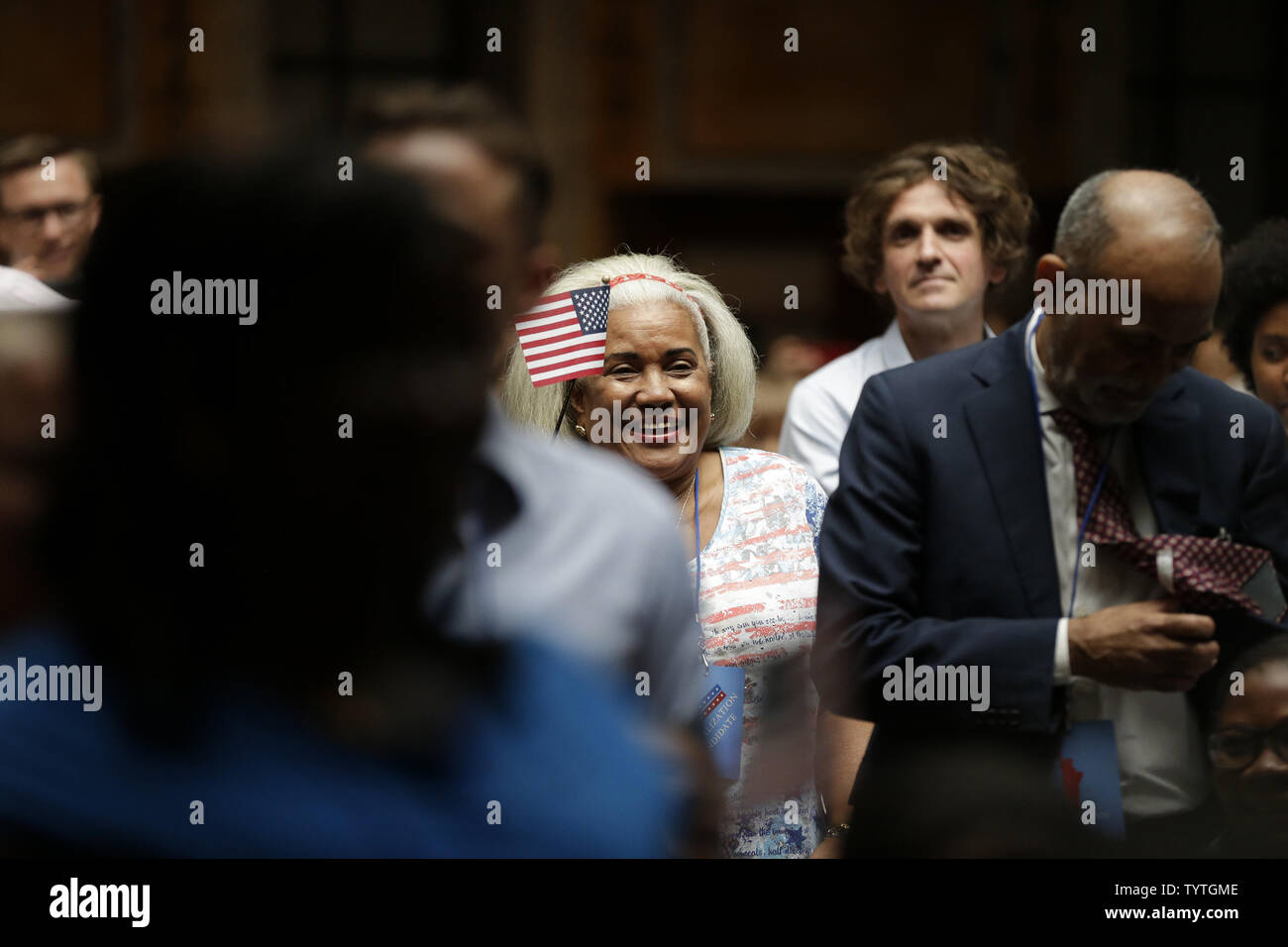 New citizens of the United States of America hold American Flags when U.S. Citizenship and Immigration Services (USCIS) administer the Oath of Allegiance to America's newest citizens during a special naturalization ceremony at the Stephen A. Schwarzmann Building of the New York Public Library in New York City on July 3, 2018. The ceremony is part of USCIS' annual Independence Day celebration.       Photo by John Angelillo/UPI Stock Photo