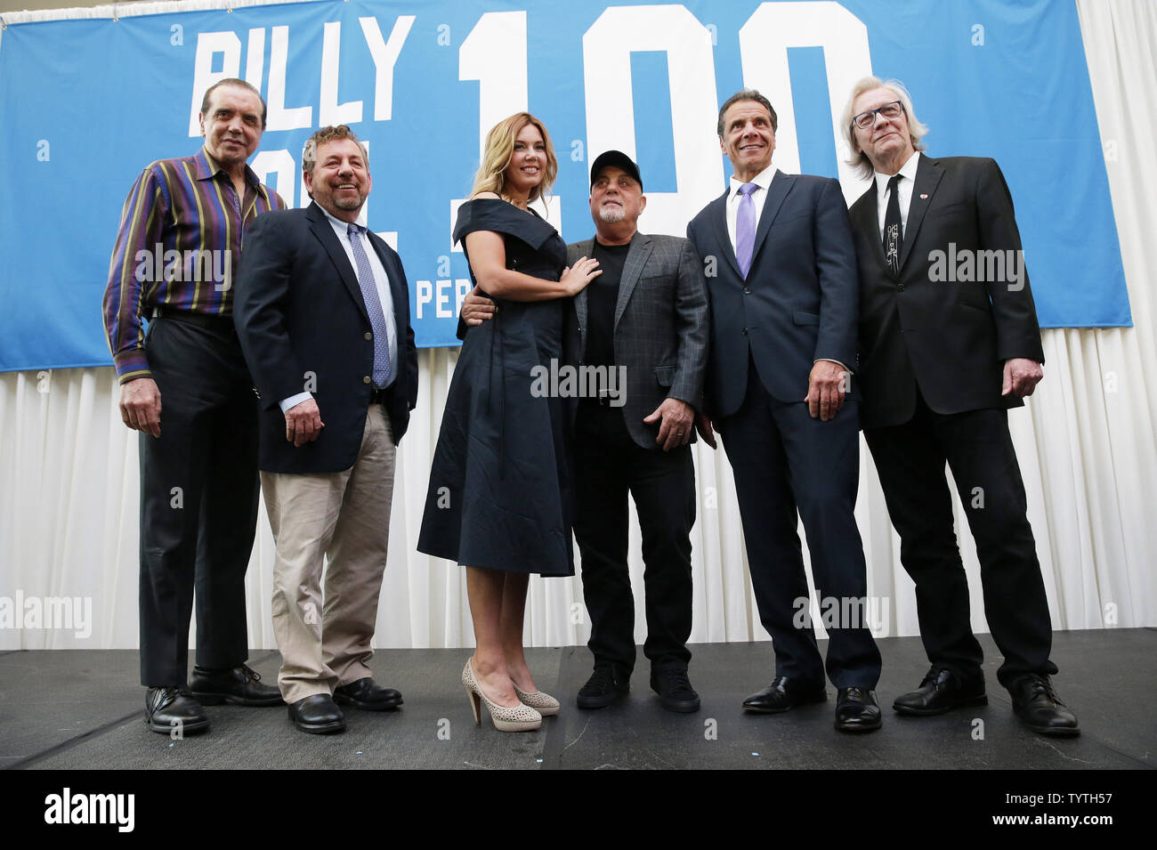 Chazz Palminteri, The Madison Square Company executive chairman and CEO James L. Dolan, Alexis Joel, Billy Joel, Governor Andrew M. Cuomo and Jim Kerr stand in front of Joel's 100 Shows banner after a press conference when The Madison Square Garden Company celebrates Billy Joel's unprecedented achievement of 100 lifetime performances at Madison Square Garden in New York City on July 18, 2018. As part of the press conference MSG made an announcement about a permanent display that will serve as a tribute to Joel's legacy. Joel's 100th lifetime performance comes 40 years after his first MSG perfo Stock Photo