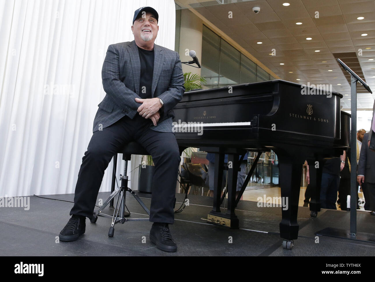 Billy Joel sits at a piano that will be a permanent fixture at MSG after a  press conference when The Madison Square Garden Company celebrates Billy  Joel's unprecedented achievement of 100 lifetime