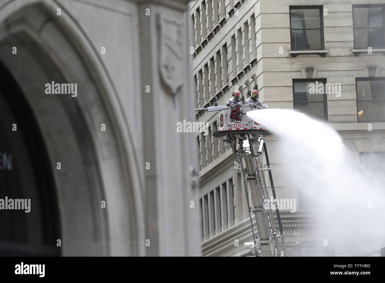 FDNY Firemen wash the sides of buildings from dust and asbestos residue ...