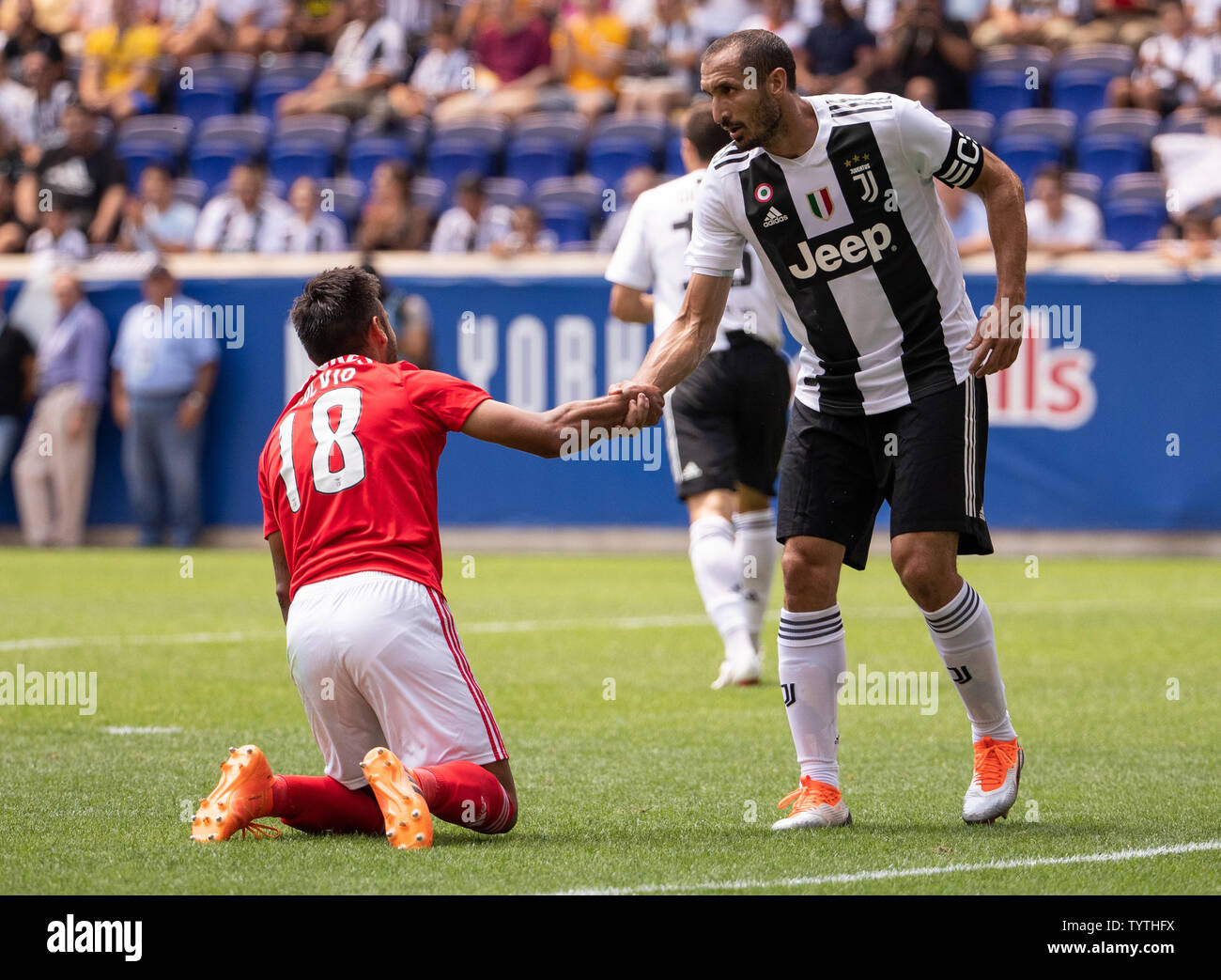 Giorgio Chiellini of Juventus helps up Eduardo Salvio of Benfica in the first half in the International Champions Cup at Red Bull Arena in Harrison, New Jersey on July 28, 2018. Juventus won in penalty kicks 4-2.      Photo by Chris Szagola/UPI Stock Photo
