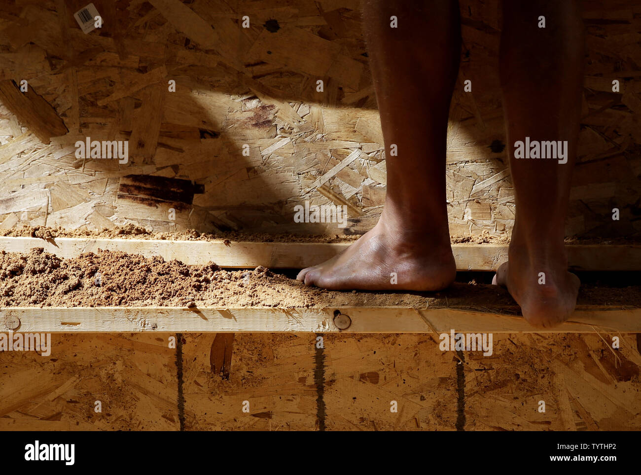 Workers build a 16foottall sand castle made of 16 tons of sand in the Channel Gardens at