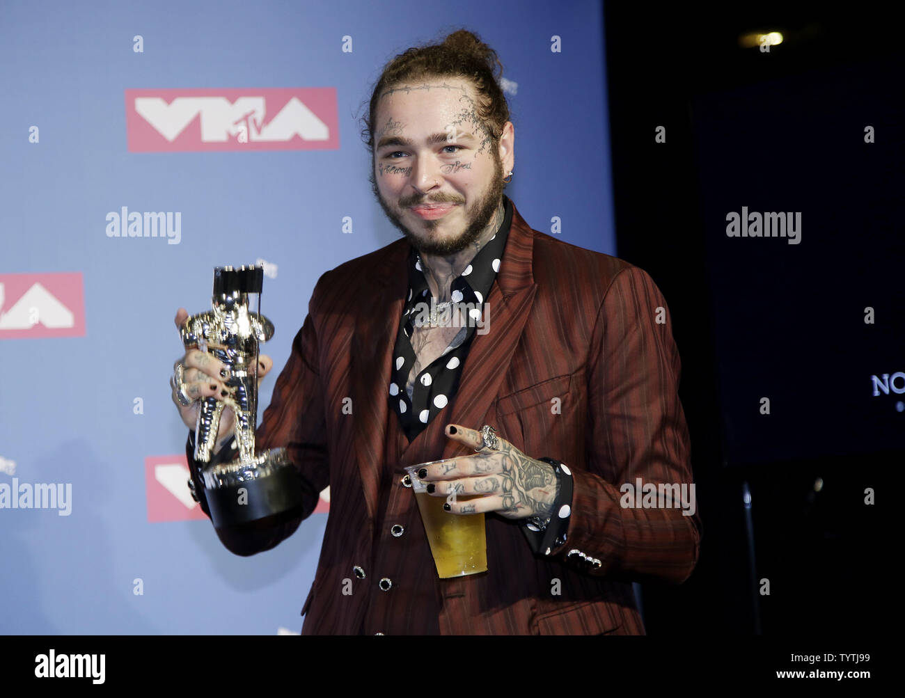 Post Malone poses with his award after winning Song of the Year at the