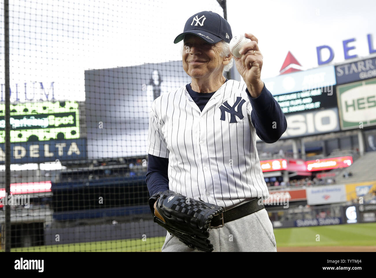 Designer Ralph Lauren stands with a glove and baseball on the field before  the New York Yankees play the Boston Red Sox at Yankee Stadium in New York  City on September 20,