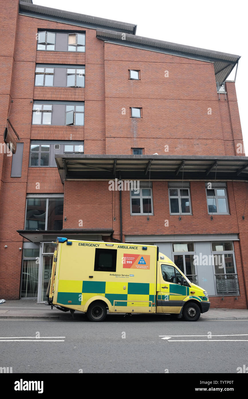 June 2019 - Bright yellow British emergency ambulance outside a residential block of apartments or flats Stock Photo