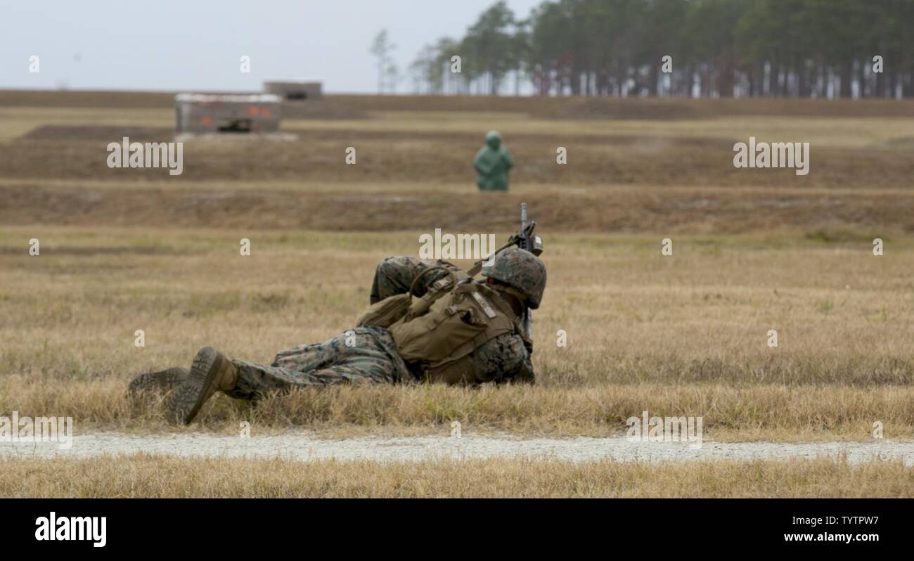 Lance Cpl. Johntaye Gore engages a target during a fire and maneuver range at Camp Lejeune, N.C., Nov. 29, 2016. The range was held in order to sharpen the fundamentals of the Marines and increase combat readiness. Gore is a rifleman with 1st Battalion, 8th Marine Regiment. Stock Photo