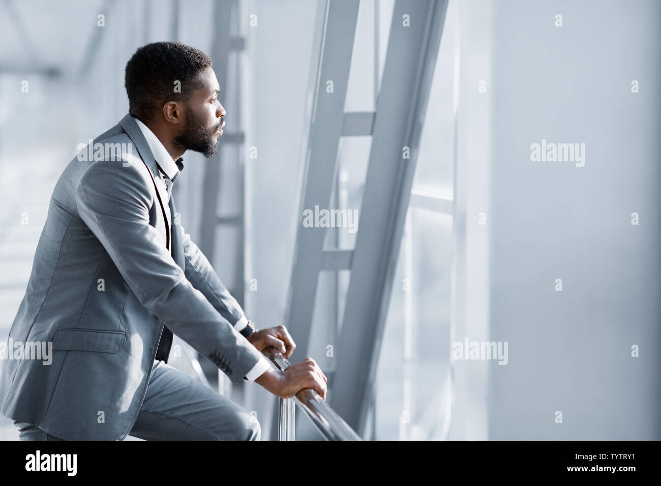 Feeling Relaxed. Confident Businessman Looking Through Window Stock Photo