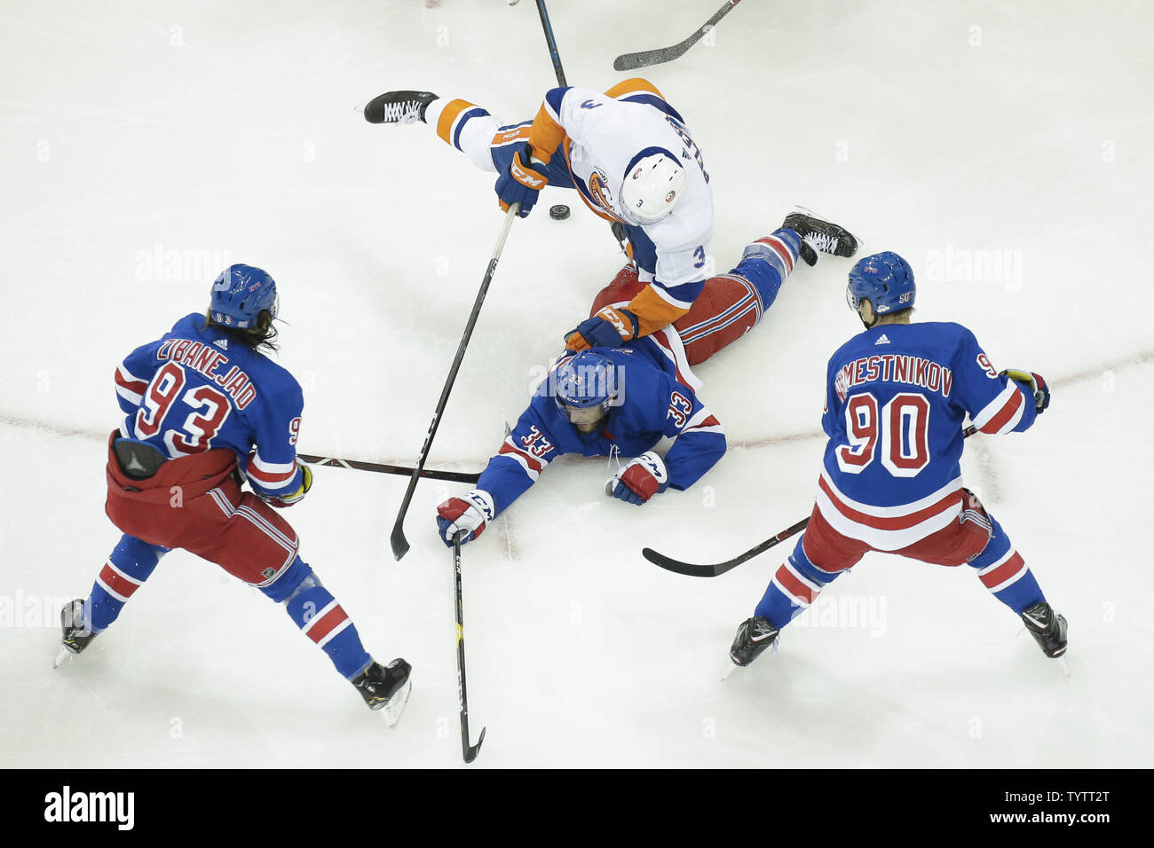 New York Islanders Adam Pelech Lands On The Back Of New York Rangers Fredrik Claesson In The First Period At Madison Square Garden In New York City On November 21 2018 Photo