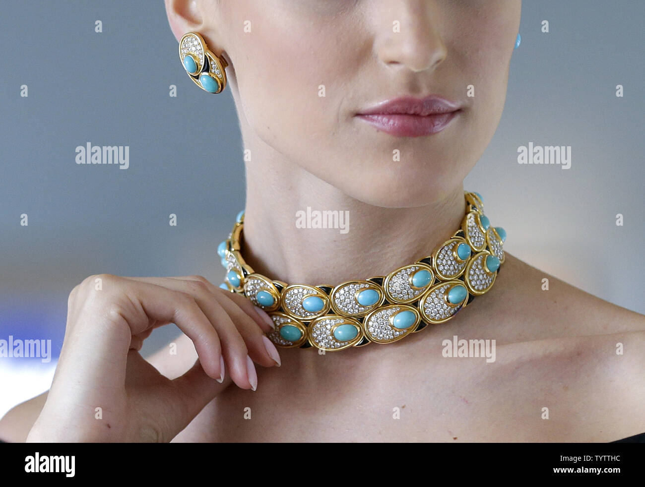 Thee women with blue body paint wearing gold jewelry Stock Photo