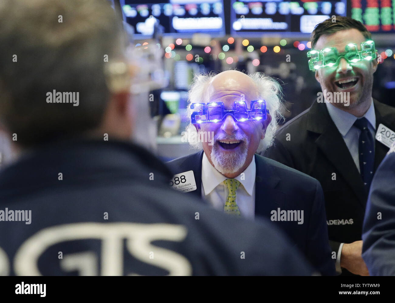Traders wear 2019 glasses when they work on the floor of the NYSE at the  closing bell on the last day of trading for 2018 at the New York Stock  Exchange on