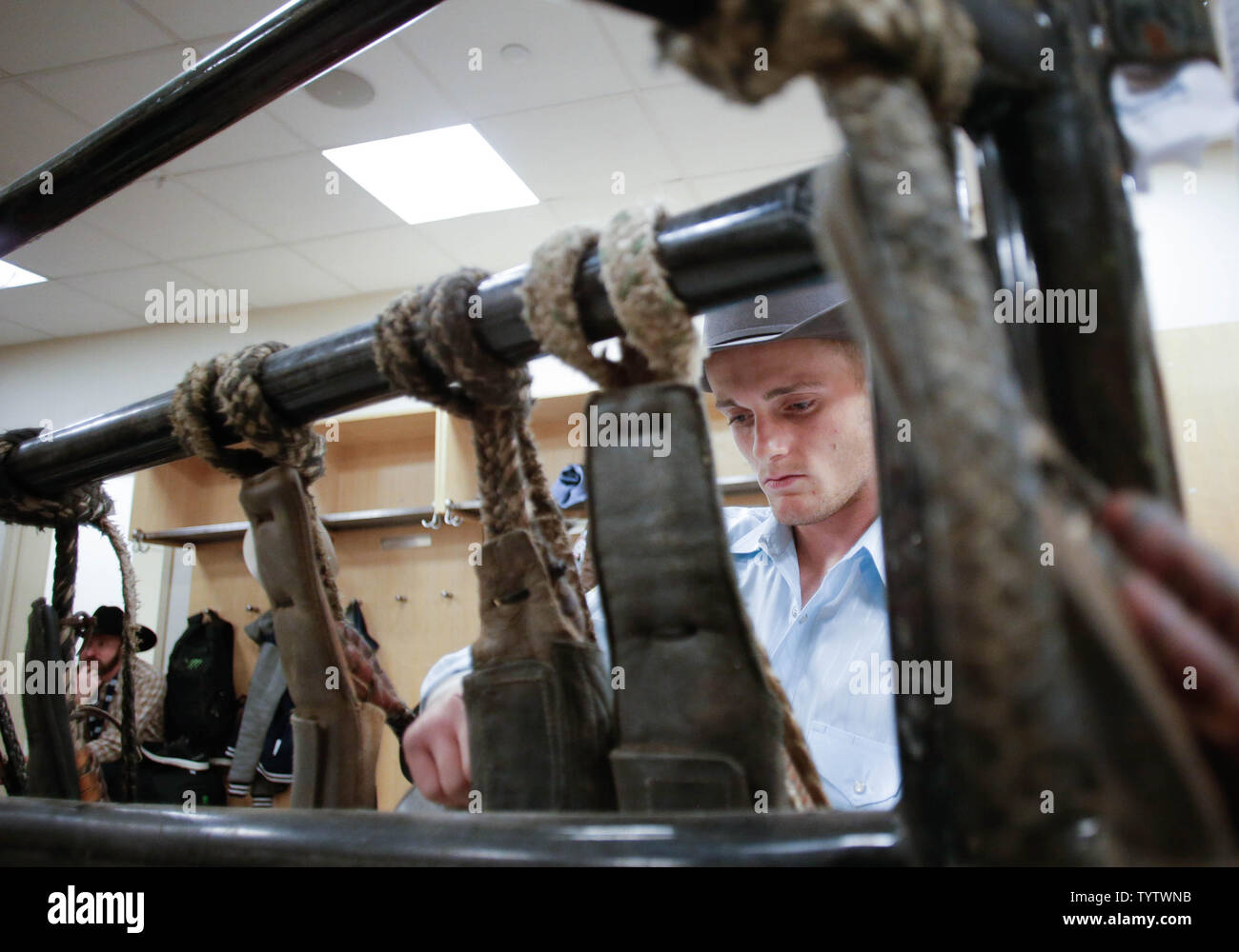 Competing bull riders get ready in the locker room at the Professional ...