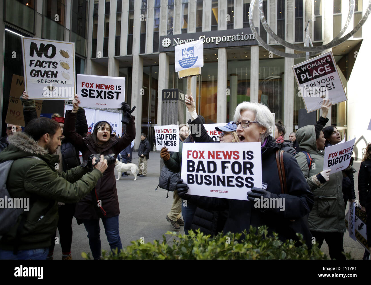 Protesters hold up signs at a rally against Fox News outside the Fox News headquarters at the News Corporation building on March 13, 2019 in New York City. The protests are taking place just as Fox News welcomes its top advertisers for a major sales meeting.   Photo by John Angelillo/UPI Stock Photo