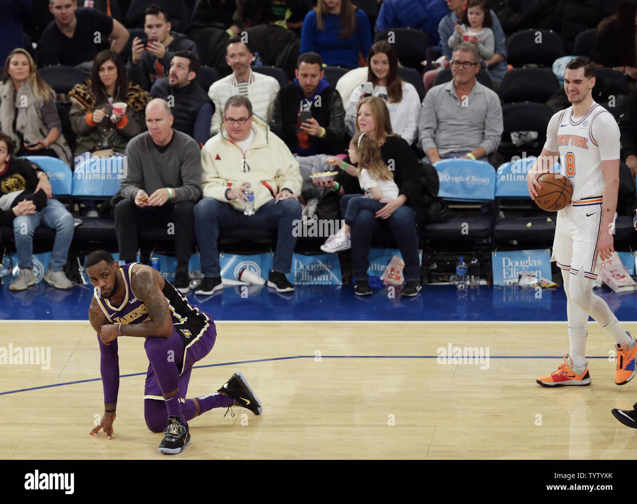 New York Knicks Mario Hezonja smiles as Los Angeles Lakers LeBron James  reacts and takes a knee after contact in the second half at Madison Square  Garden in New York City on