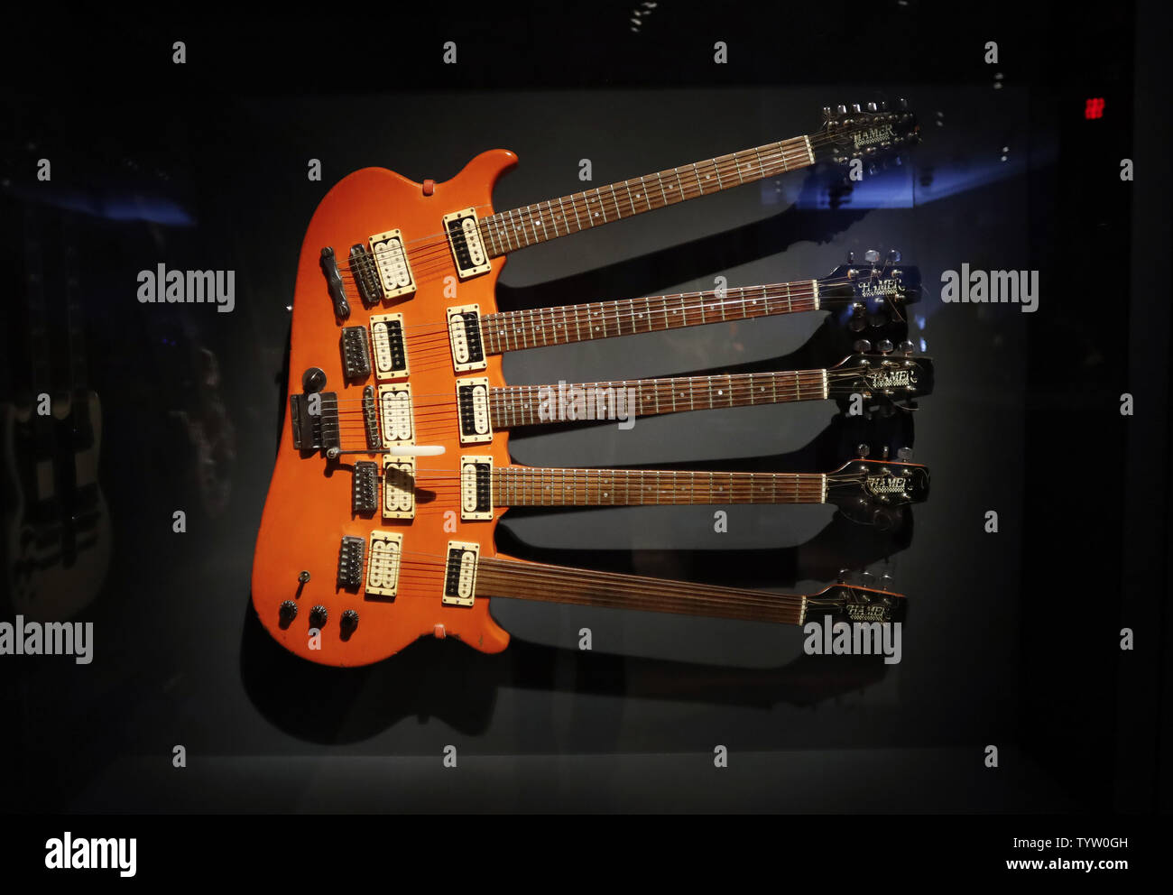 A Hamer 5 neck guitar from Cheep Trick's Rick Nielsen is on display at a press preview for Play It Loud: Instruments of Rock & Roll at Metropolitan Museum of Art on April 1, 2019 in New York City. A groundbreaking exhibition presenting a spectacular array of iconic instruments of rock and roll will go on view at The Met on April 8. The exhibition includes Chuck Berry's electric guitar ES-350T (1957), which was used to record "Johnny B. Goode"; a reconstructed performance rig from Eddie Van Halen as it appeared onstage in 1978; Lady Gaga's custom-designed piano; Stevie Ray Vaughan's composite s Stock Photo